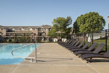 Pool with lounge chairs at Highland View Apartments in north Lincoln NE 68521 - Photo Gallery 30