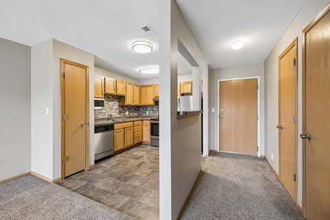 A kitchen and hallway are shown in this image.