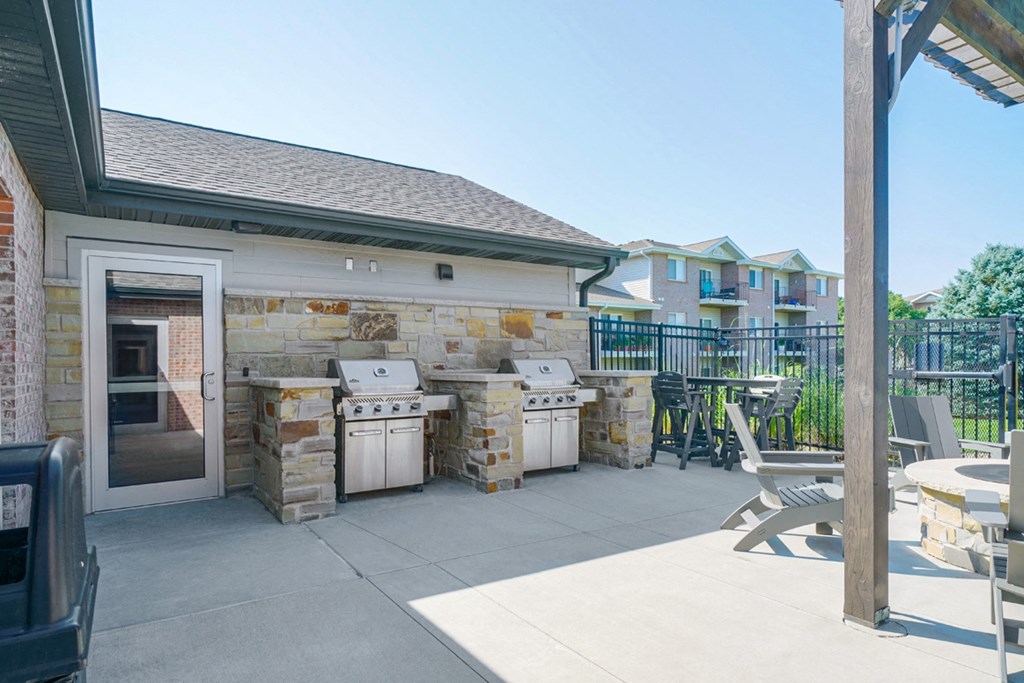 two poolside gas grills with grilling stations