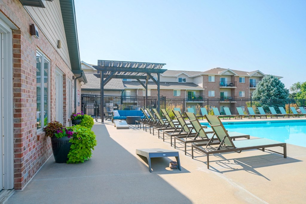 outdoor activity space on the pool deck with cornhole and lounge seating
