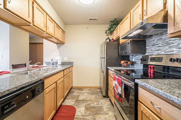 Galley style kitchen with up-to-date appliances at Skyline View Apartments in Lincoln NE