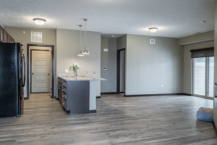 Large windows and natural lighting in large open floor plan kitchen and living space at North Pointe Villas