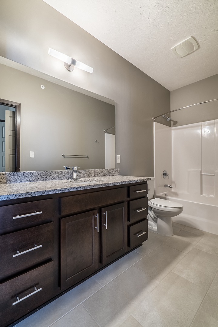 Large bathroom with granite countertops and a bathtub at North Pointe Villas