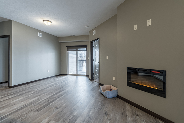 Open floor plan living space including a fireplace at North Pointe Villas in Lincoln NE