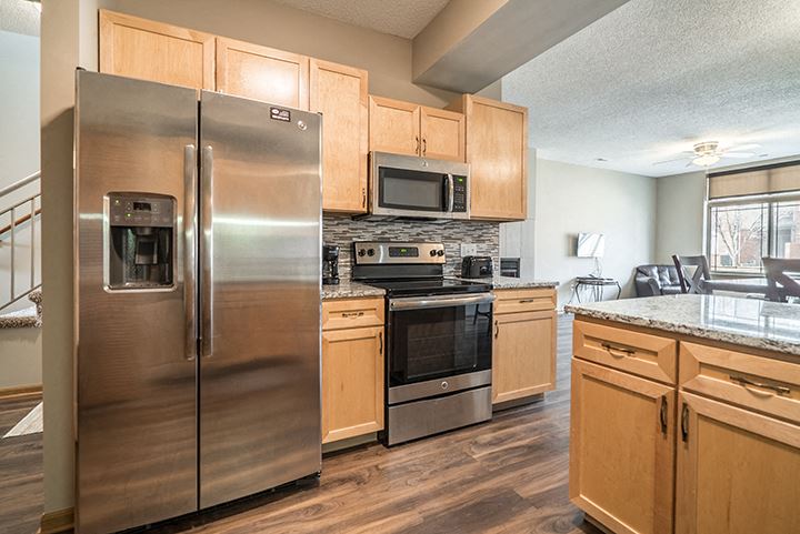 Upgraded unit with side-by-side stainless steel fridge and appliances at Southwind Villas townhomes in La Vista, NE, 68128 - Photo Gallery 1