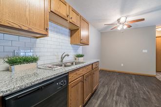 bright kitchen with granite countertop at Williamsburg Park Apartments in Lincoln NE