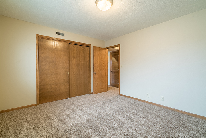 Spacious bedroom with closet space at Fountain Glen Apartments