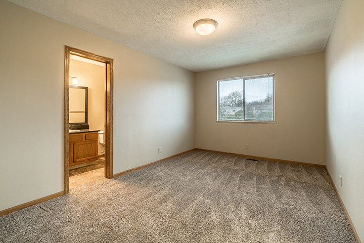 Bedroom with attached bathroom at Fountain Glen Apartments