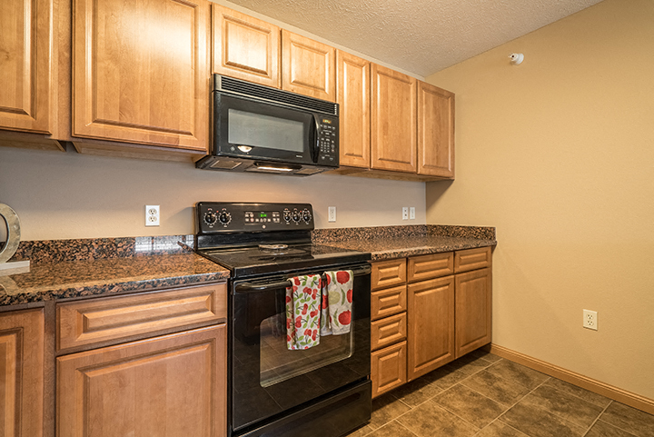 Kitchen with updated appliances at Grand Legacy Apartments