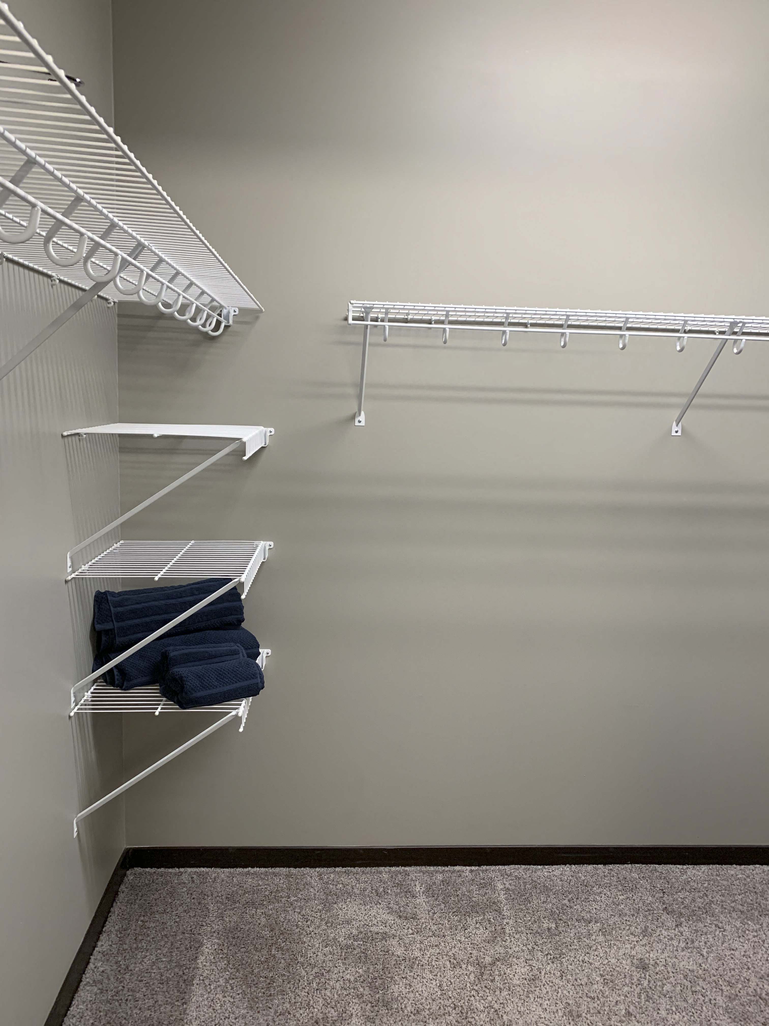 Large walk in closet with shelves for clothing storage in a 3 bedroom villa