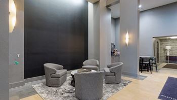 Lobby at Midtown Crossing Apartments in Omaha Nebraska featuring plenty of seating and a coffee station