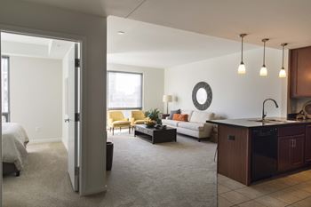 View from the hallway of the living room, kitchen, and into the bedroom of a Midtown Crossing apartment