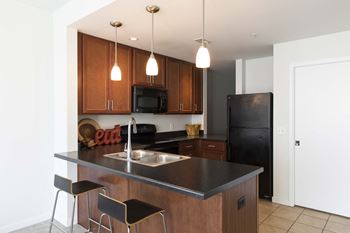 Spacious full size kitchen with high end appliances and seating at a breakfast bar
