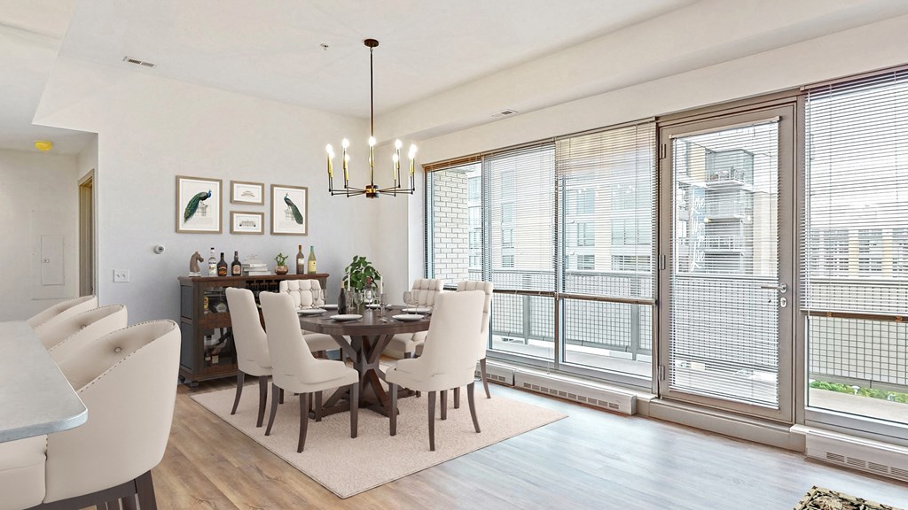 Enjoy the scenic views from the floor-to-ceiling windows in the dining and living area of a 2 bedroom penthouse floor plan at Midtown Crossing Apartments Omaha