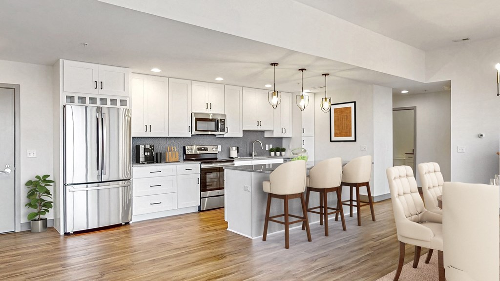 Create your culinary masterpiece in this chef’s kitchen with seated island, stainless steel appliances, granite counter tops and custom tile backsplash in this 2 bedroom penthouse floor plan at Midtown Crossing Apartments Omaha.