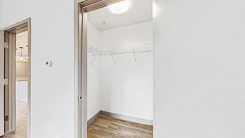 spacious walk in closet with light at midtown crossing apartments