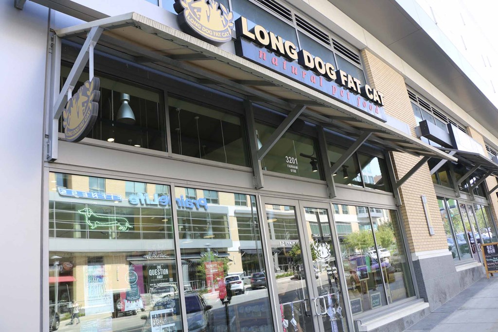 the front of a store with glass doors and a sign that reads