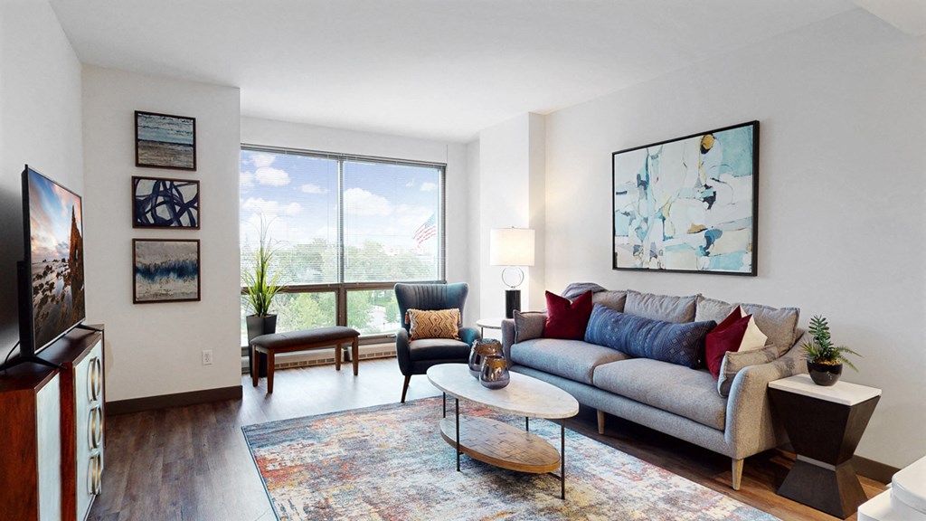 Enjoy the scenic views from the floor-to-ceiling windows in the living area of a 1 bedroom floor plan at Midtown Crossing Apartments Omaha