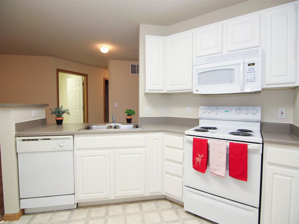 Kitchen with stove and dishwasher at Northbrook Apartments in Lincoln NE