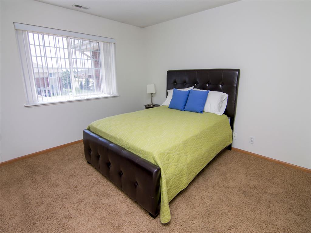 Bedroom with large window in The Northbrook Apartments in Lincoln NE