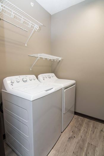 A white dryer and washer in a laundry room.
