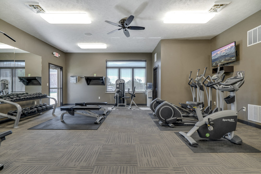 Fitness center with free weights and cardio equipment at North Pointe Villas