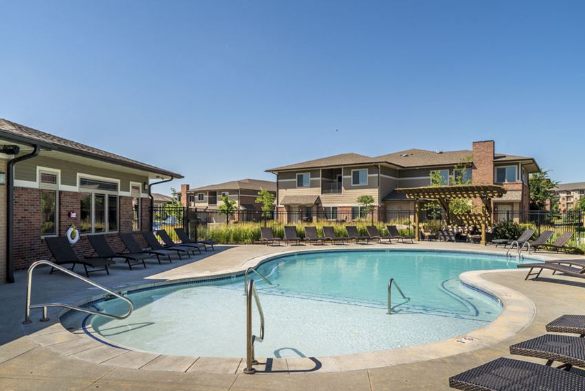 Resort style pool with lounge chairs at North Pointe Villas in Lincoln - Photo Gallery 1