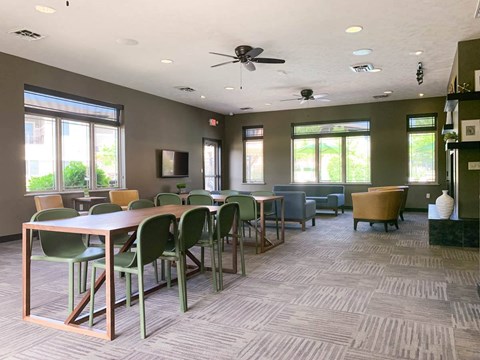 a conference room with tables and chairs and a ceiling fan