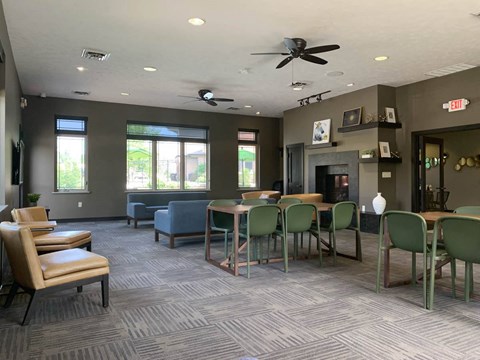 a great room with tables and chairs and a fireplace