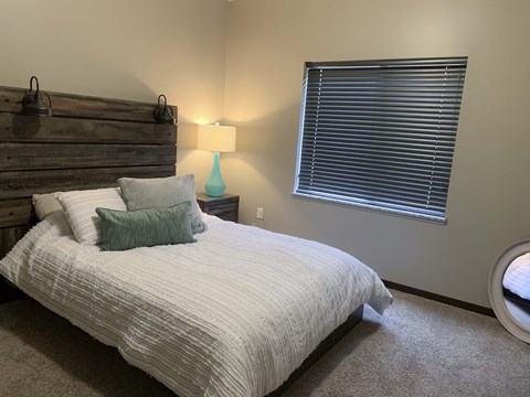 Furnished bed room with full size bed at north pointe villas in lincoln nebraska
