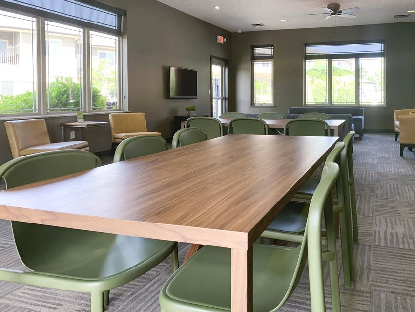 large table with six green chairs