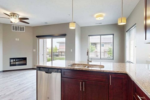 A view of the living room and dining area from the kitchen peninsula.