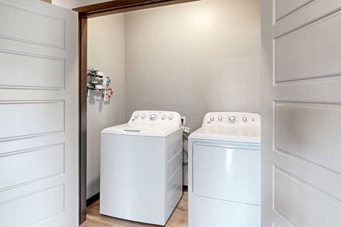 A full sized washer and dryer in a double door closet.