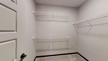 a walk-in closet with built-in shelving and hanging space