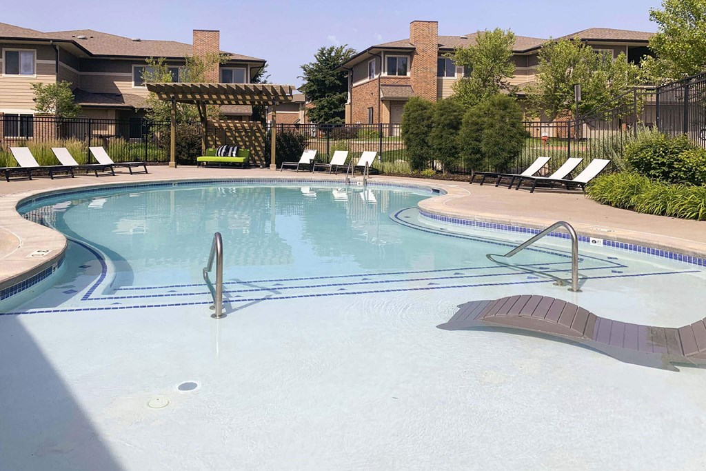 Resort style swimming pool with sun tanning loungers at North Pointe  Villas Lincoln Nebraska