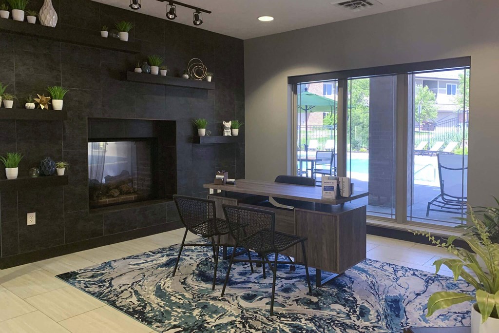 front desk with two chairs and a large window in the clubhouse at north pointe villas in lincoln