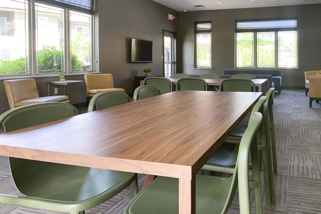 large table with six green chairs