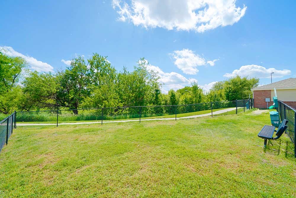 a fenced in dog park with open green space to let your dog off-leash
