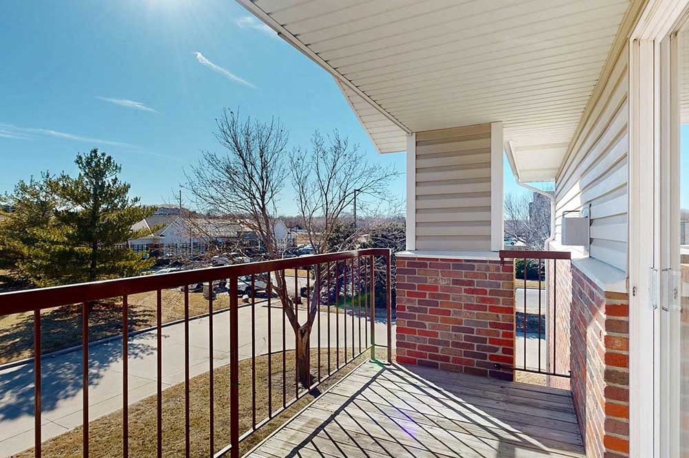 balcony view overlooking trees and yard