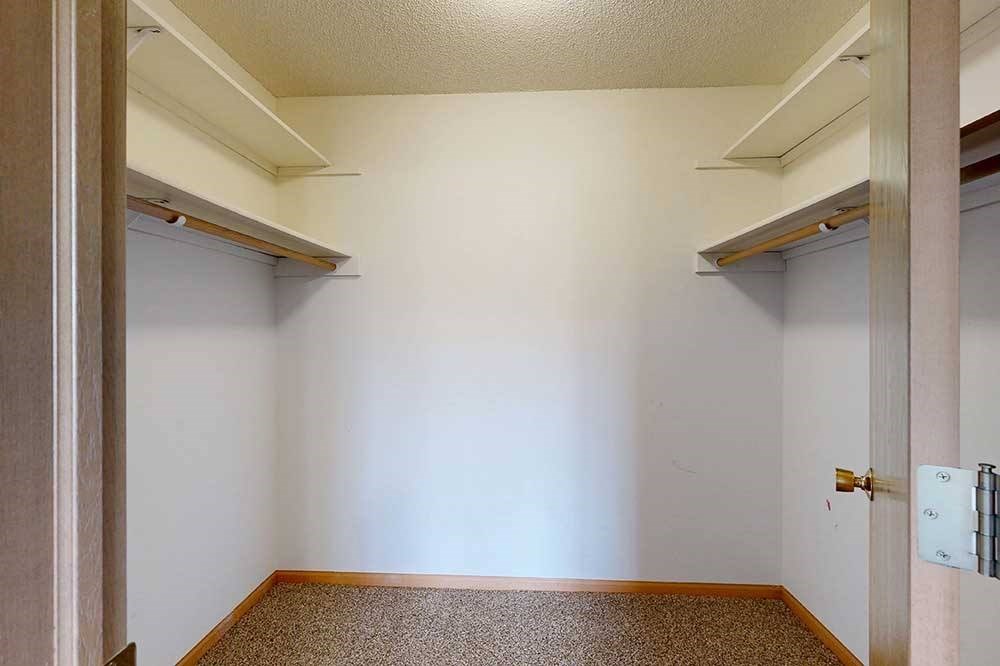 large walk in closet with shelving
