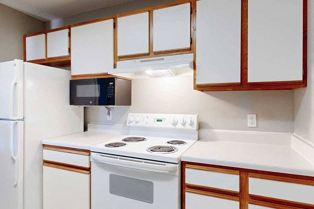 kitchen with white stove with a microwave and refridgerator
