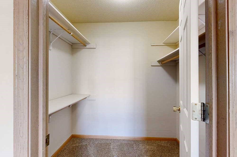 large walk-in closets with a shelving and storage
