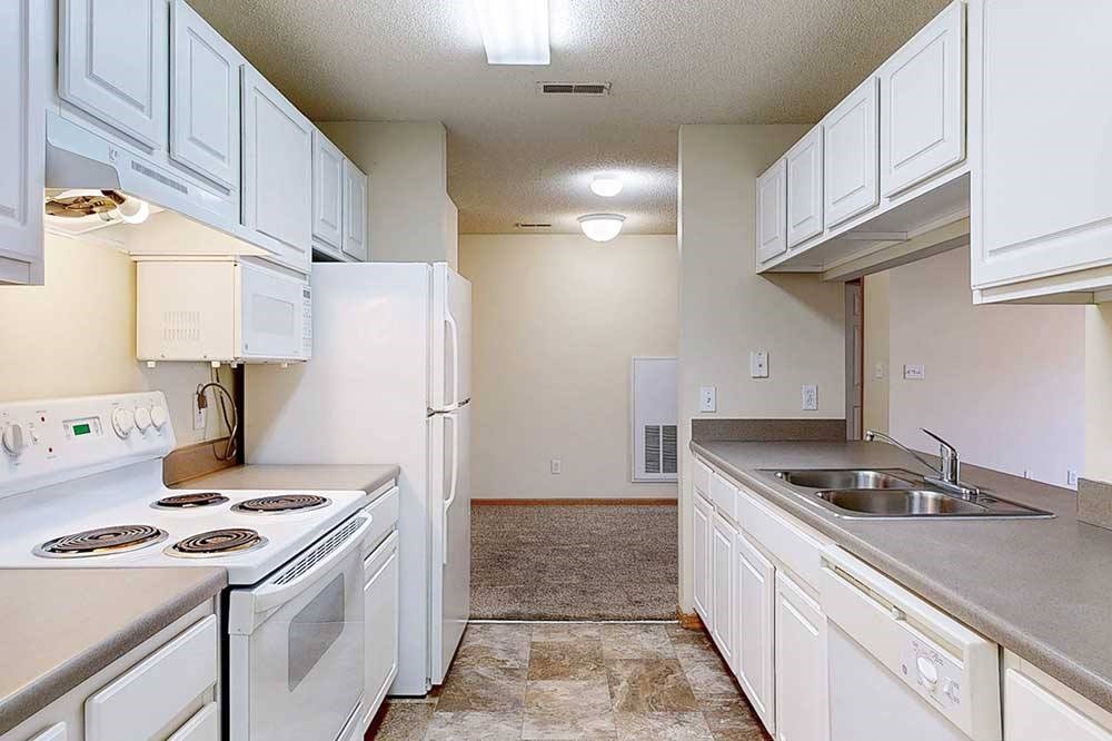 a kitchen with white appliances and cabinets