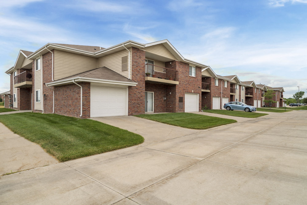 Exterior of Northbrook Apartments with attached garages and lawns