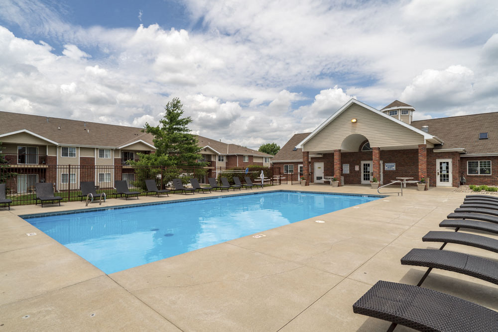 Large outdoor pool with lounge chairs at The Northbrook Apartments in Lincoln, NE 68504