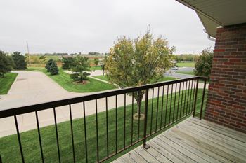 a view of a yard from the balcony of a house