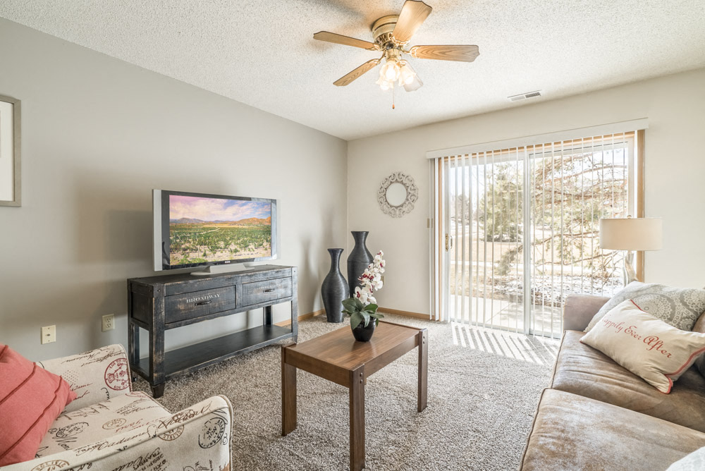 Bright living room with walkout patio and natural lighting