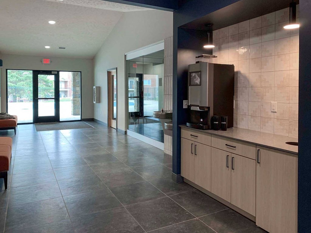 a lobby with a coffee maker and two drinking fountains