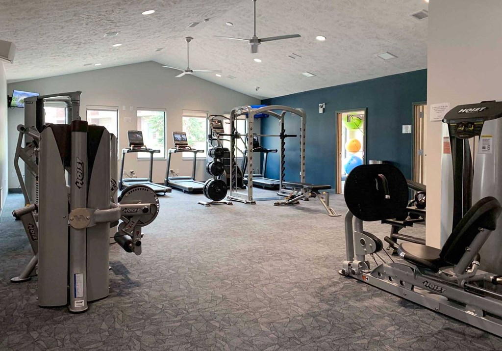 a gym with weights and other exercise equipment in a room