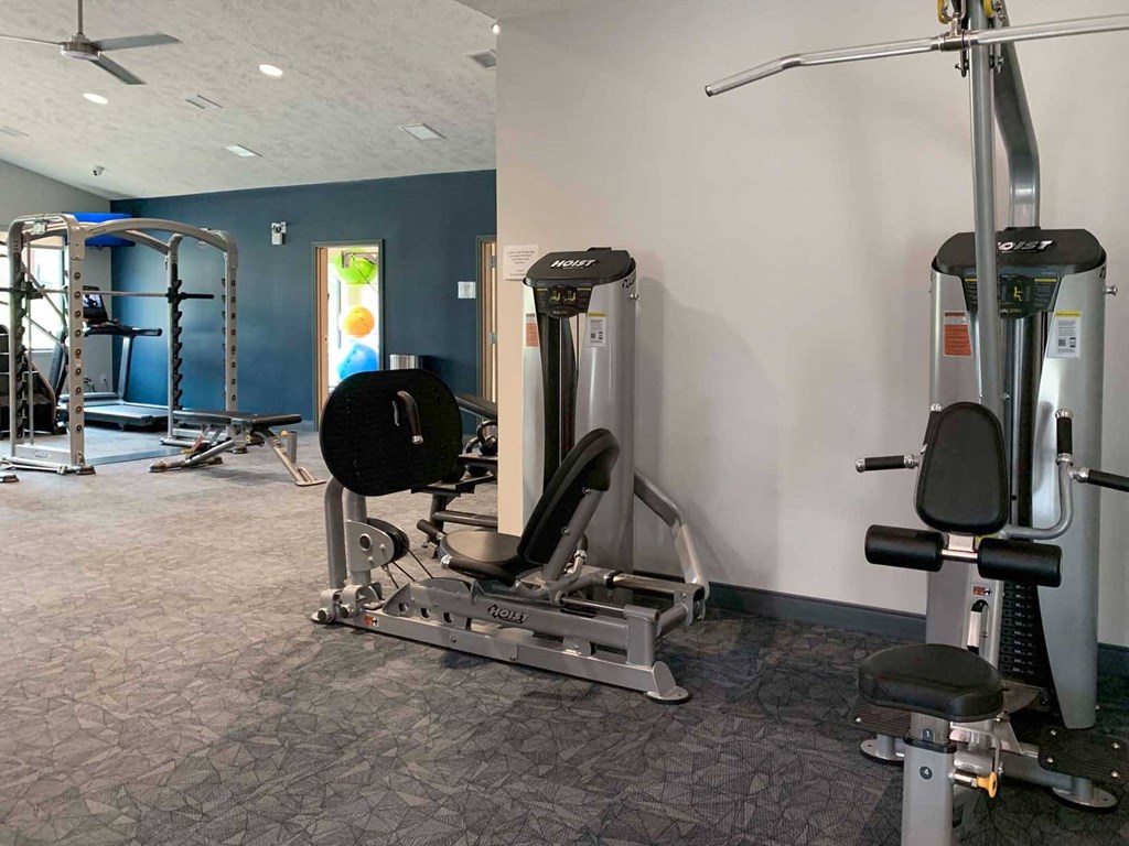 a gym with weights and other exercise equipment in a room